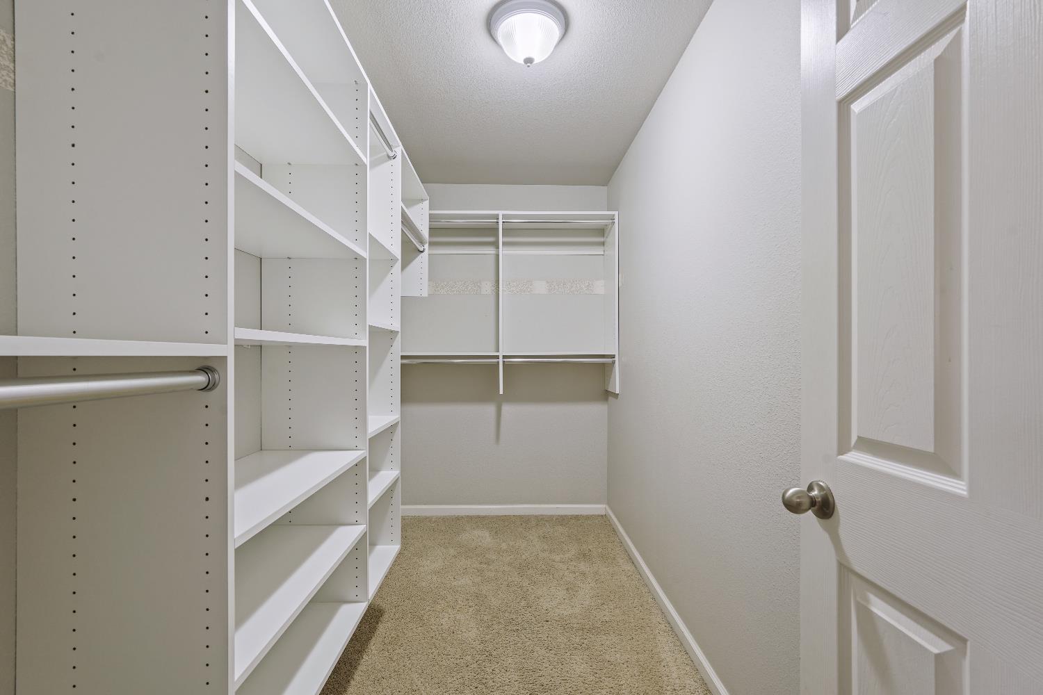 8760 Greer Way Valley Springs, CA 95252 - Photo 31 of 40 a view of walk in closet with empty racks