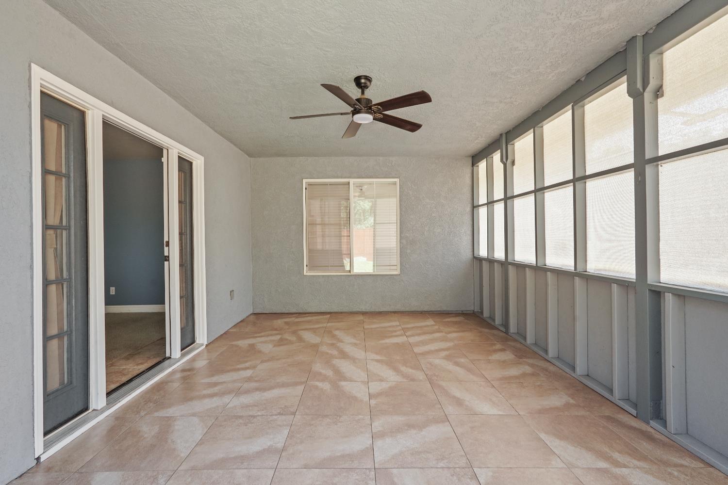 8760 Greer Way Valley Springs, CA 95252 - Photo 33 of 40 a view of a livingroom with a ceiling fan and windows