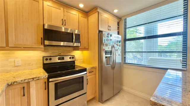 a kitchen with a stove microwave and refrigerator