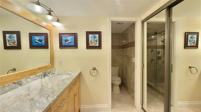 a bathroom with a granite countertop tub sink and mirror