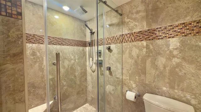 a bathroom with a shower and toilet
