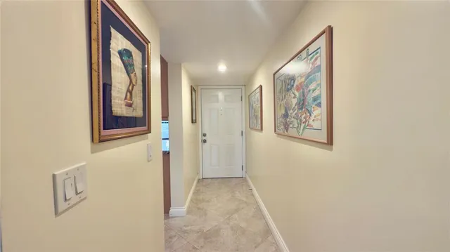 a view of a hallway with paintings on the wall