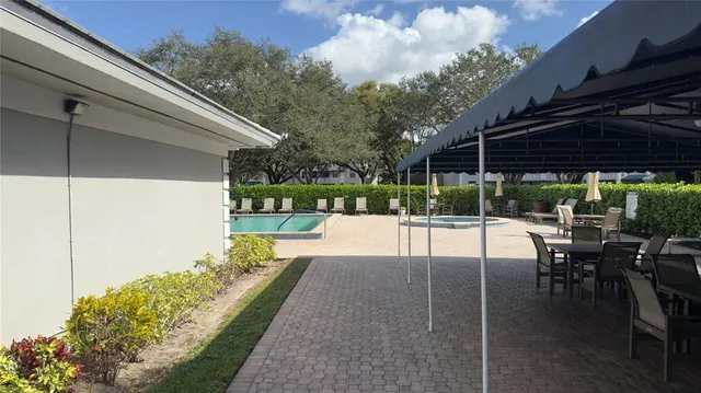 a view of a patio with a table chairs and a table