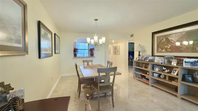 a view of a dining room with furniture and chandelier