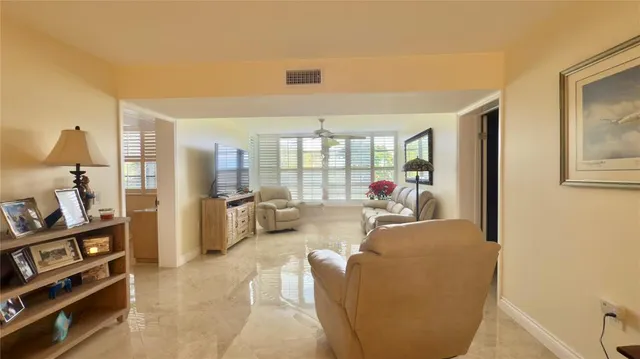 a living room with furniture cabinets and a flat screen tv