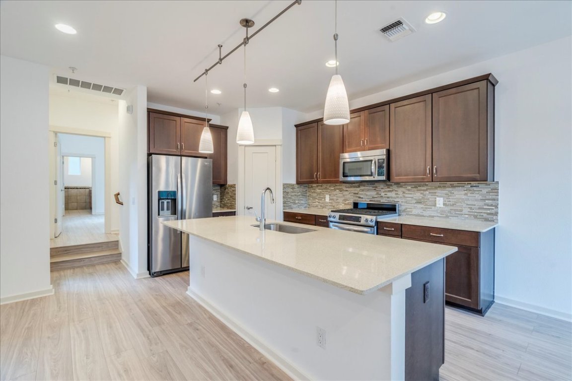 4006 Valley View Road, Unit B Austin, TX 78704 - Photo 1 of 32 a kitchen with a sink a counter top space stainless steel appliances and cabinets