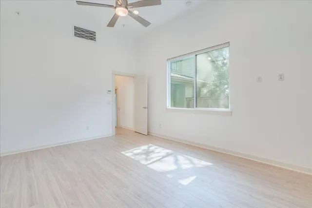 a large kitchen with stainless steel appliances a large counter top a stove and a wooden floors