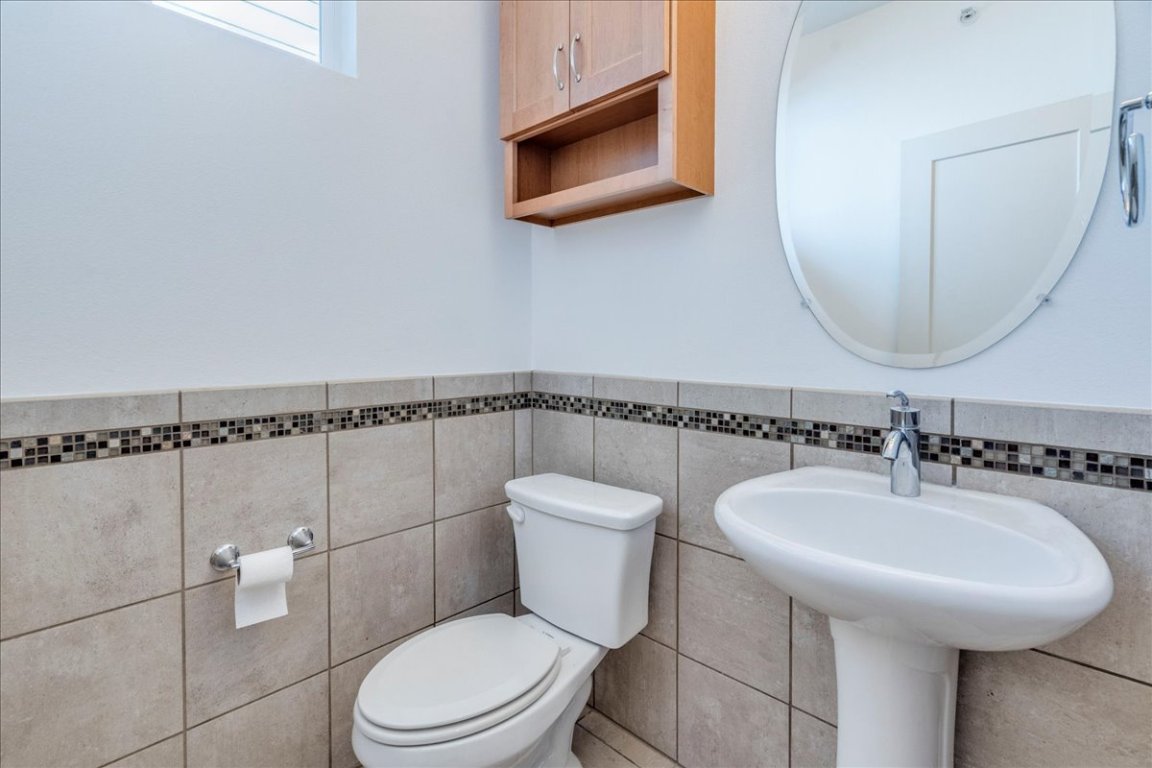 4006 Valley View Road, Unit B Austin, TX 78704 - Photo 12 of 32 a bathroom with a toilet a sink and mirror