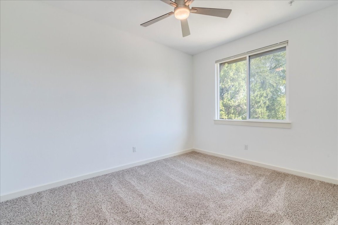 4006 Valley View Road, Unit B Austin, TX 78704 - Photo 14 of 32 an empty room with a window and a fan