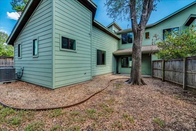 a view of a backyard with wooden fence
