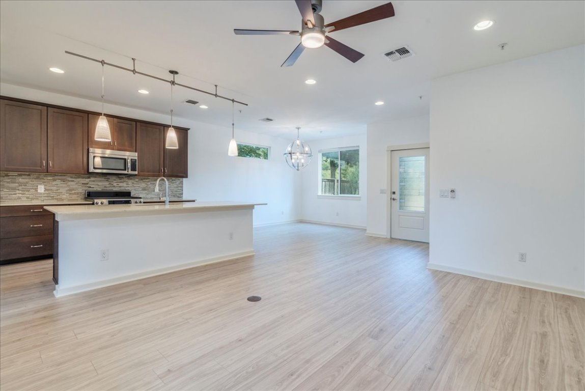 4006 Valley View Road, Unit B Austin, TX 78704 - Photo 32 of 32 a large kitchen with stainless steel appliances a large counter top a stove and a wooden floors