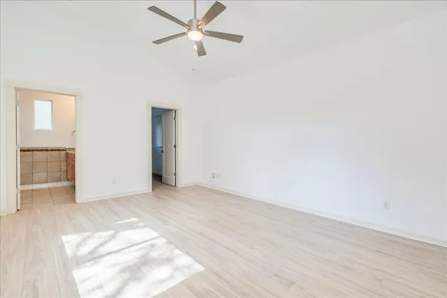 a view of kitchen with kitchen island wooden floor center island and appliances