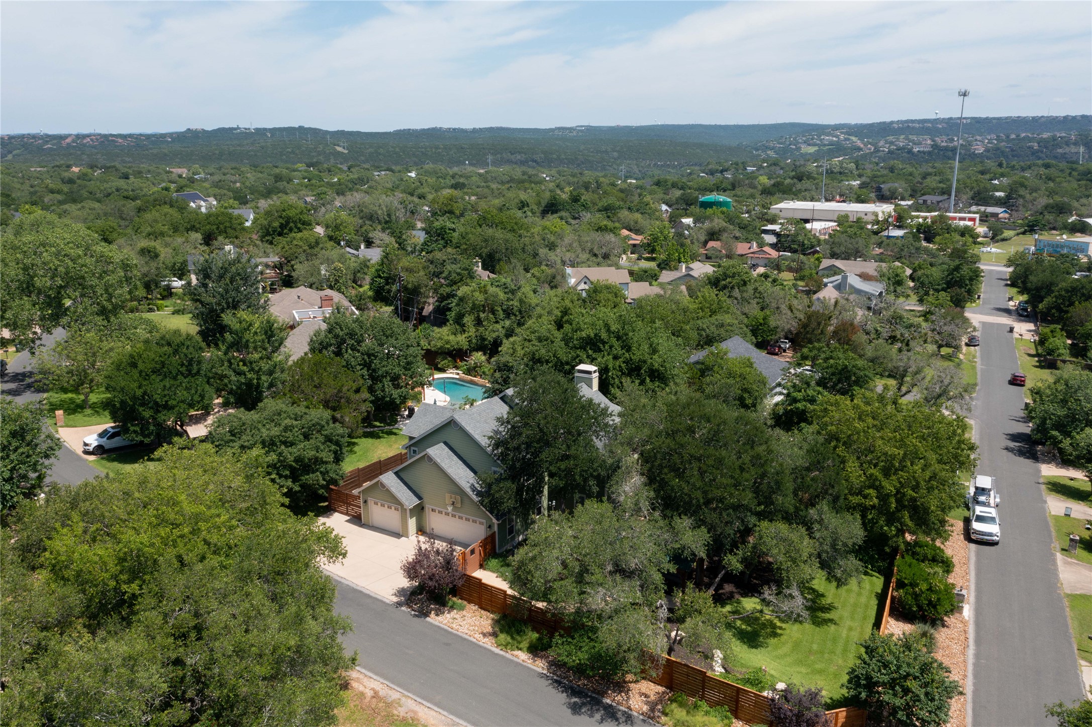 1204 Orlando Road Austin, TX 78733 - Photo 1 of 40 An aerial perspective reveals a private pool oasis nestled amongst a verdant, tree-filled landscape.