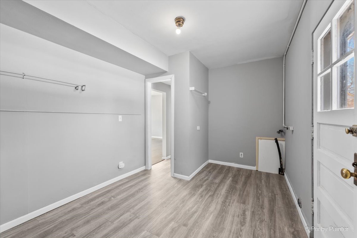 2629 North McAree Road Waukegan, IL 60087 - Photo 18 of 28 wooden floor in an empty room with a window
