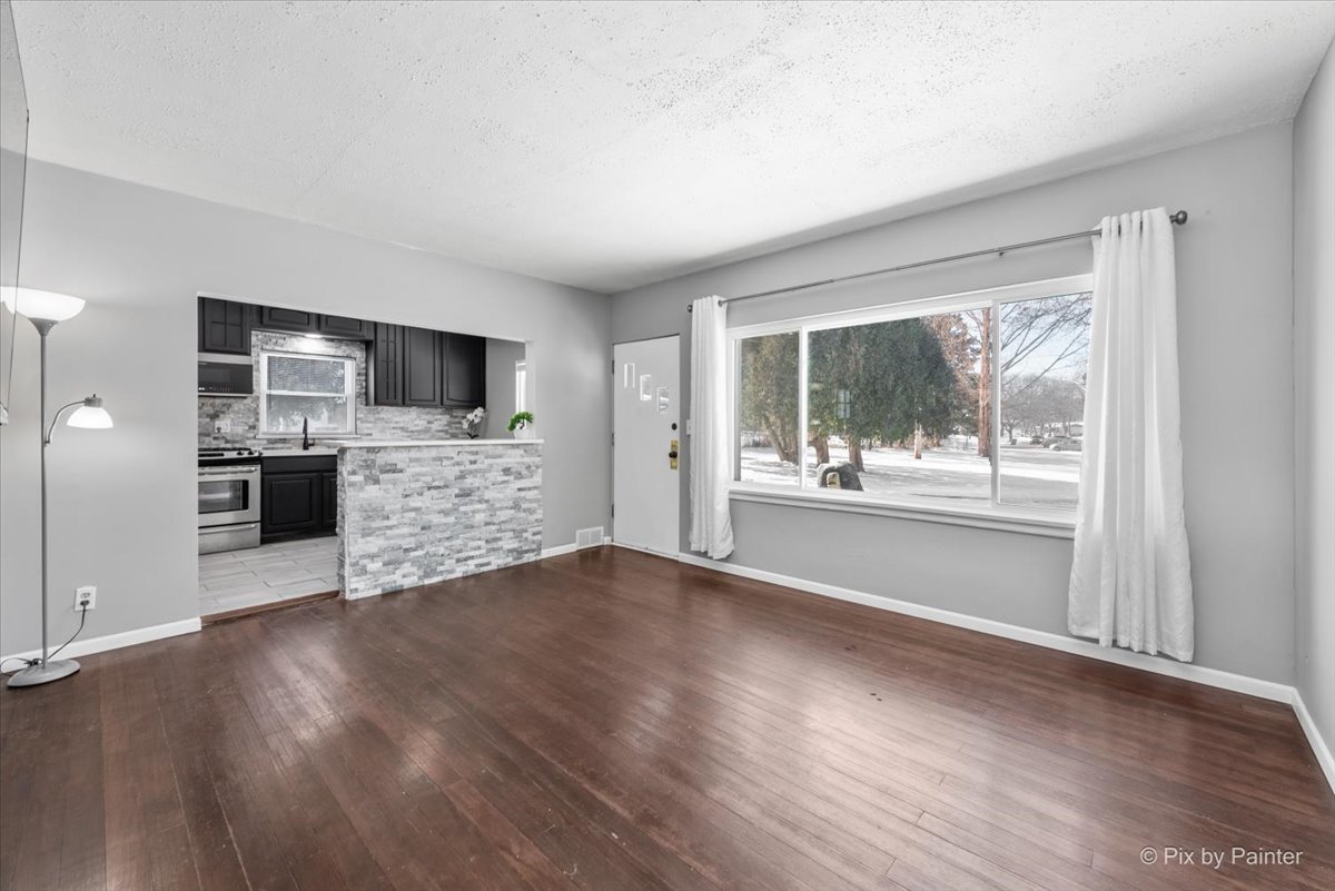 2629 North McAree Road Waukegan, IL 60087 - Photo 6 of 28 a view of an empty room with a window and a kitchen