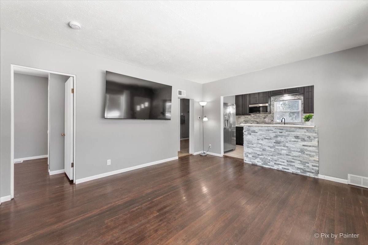 2629 North McAree Road Waukegan, IL 60087 - Photo 8 of 28 an empty room with wooden floor and ceiling fan