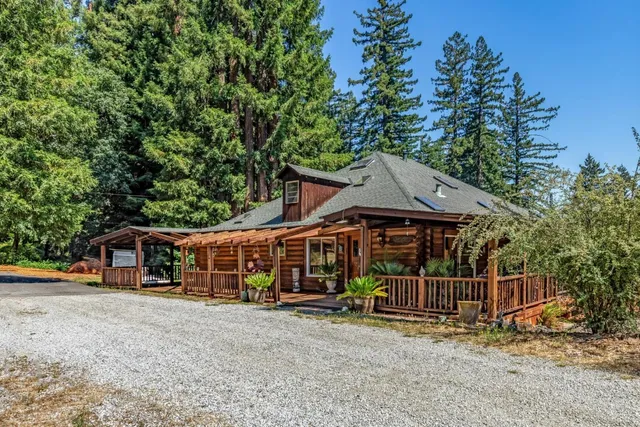 a front view of house with a garden