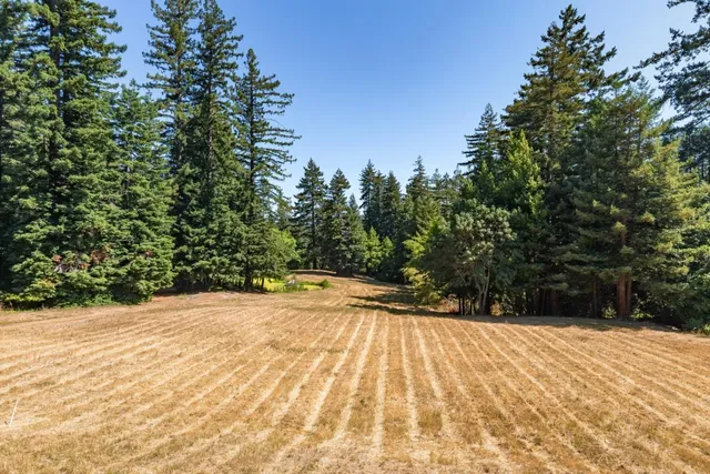 a large bed sitting in a bedroom next to a window