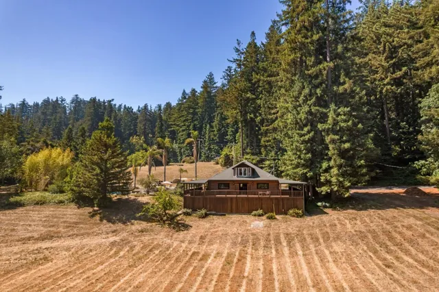 a front view of a house with a yard covered in snow