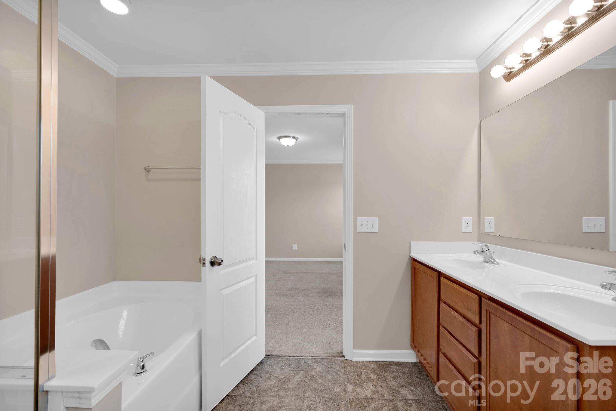 13718 Porter Creek Road Charlotte, NC 28262 - Photo 27 of 45 a bathroom with a tub sink and mirror