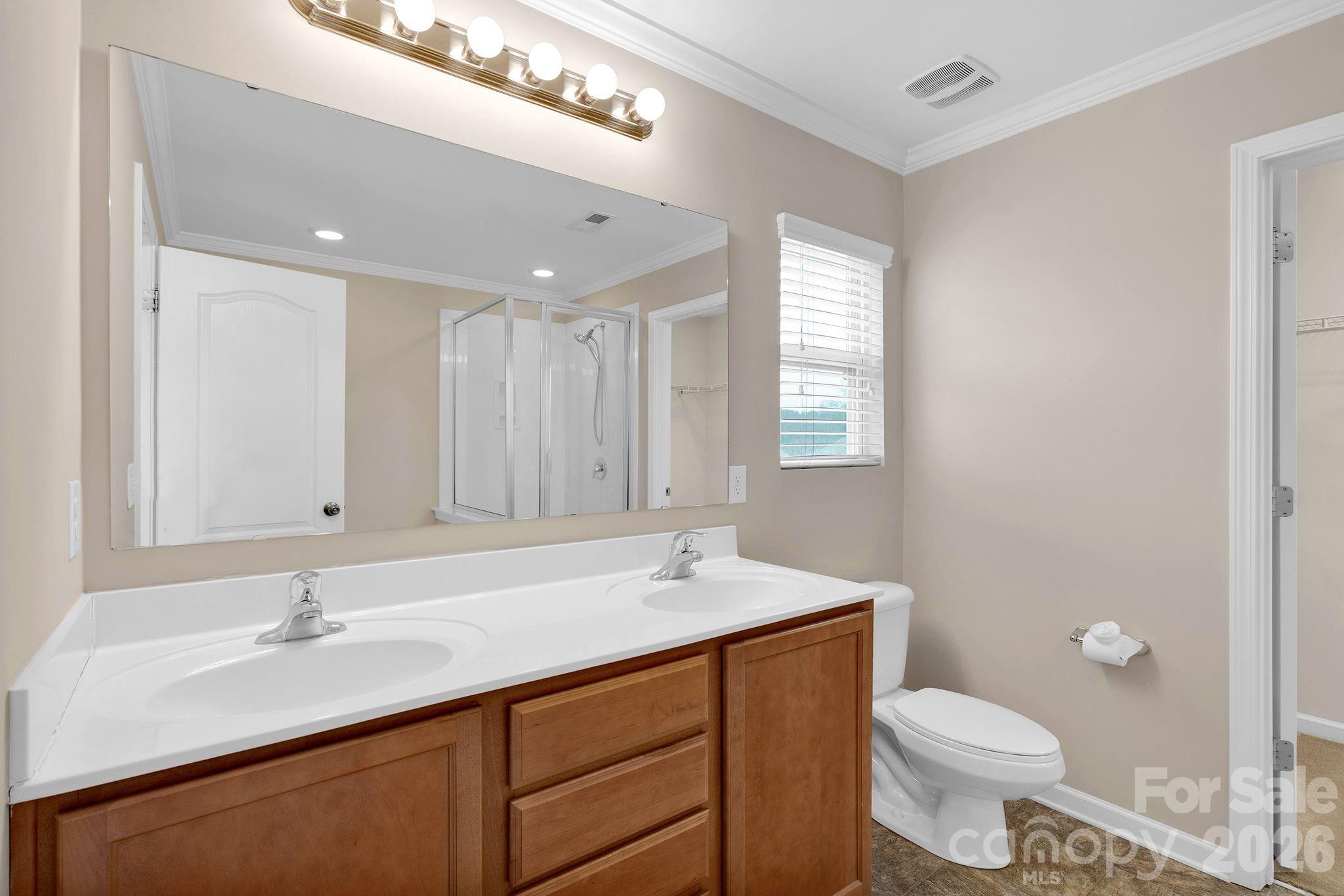 13718 Porter Creek Road Charlotte, NC 28262 - Photo 28 of 45 a bathroom with a sink and a toilet