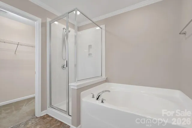 a bathroom with a tub a shower and a sink