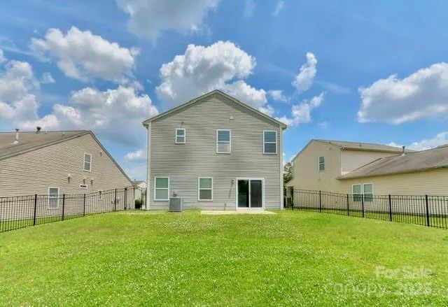 a view of a house with a big yard and large trees