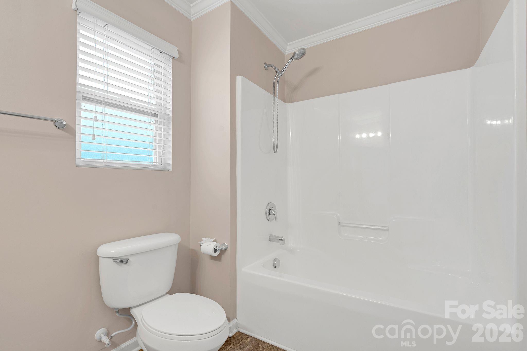 13718 Porter Creek Road Charlotte, NC 28262 - Photo 36 of 45 a white toilet sitting next to a bath tub shower