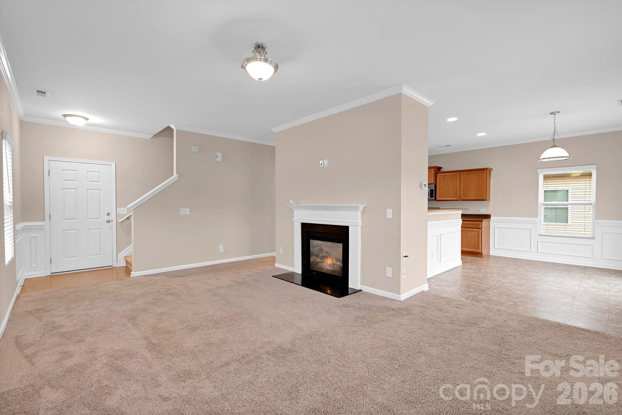13718 Porter Creek Road Charlotte, NC 28262 - Photo 4 of 45 an empty room with windows and fireplace