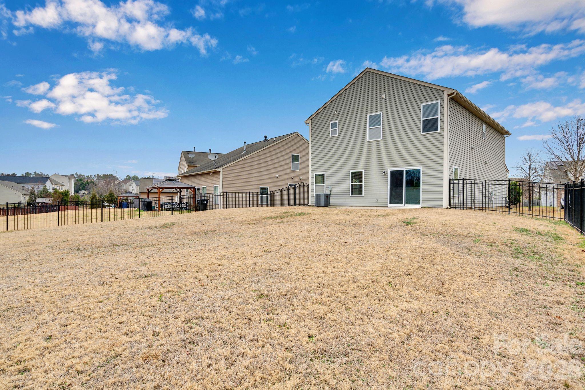 13718 Porter Creek Road Charlotte, NC 28262 - Photo 44 of 45 a large white house with a large pool of the house