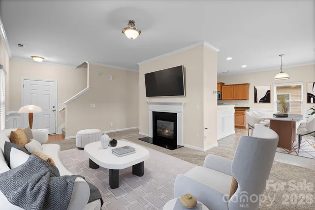 a living room with furniture a fireplace and a flat screen tv