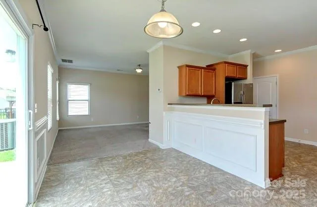 a view of a kitchen cabinets and a refrigerator