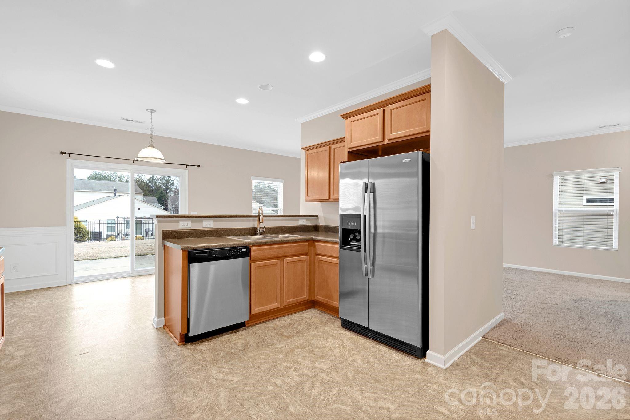 13718 Porter Creek Road Charlotte, NC 28262 - Photo 9 of 45 a kitchen with stainless steel appliances granite countertop a refrigerator a sink a stove and a microwave