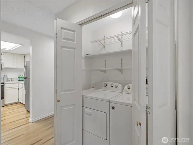 a utility room with cabinets washer and dryer