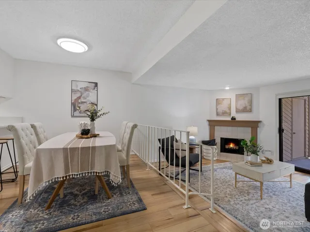 a living room with furniture a fireplace and a table