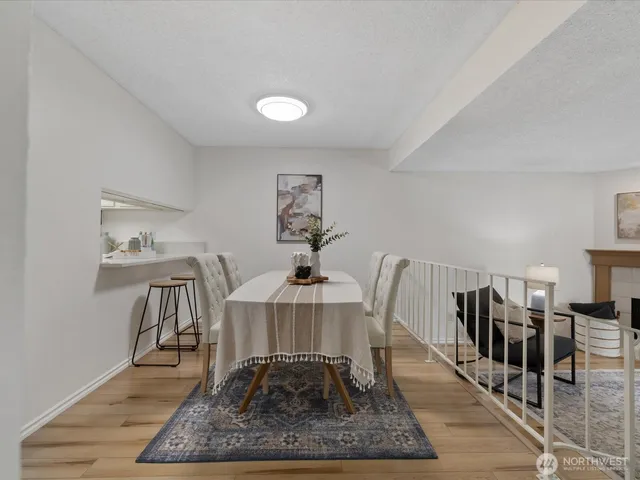 a living room with furniture a rug and a table