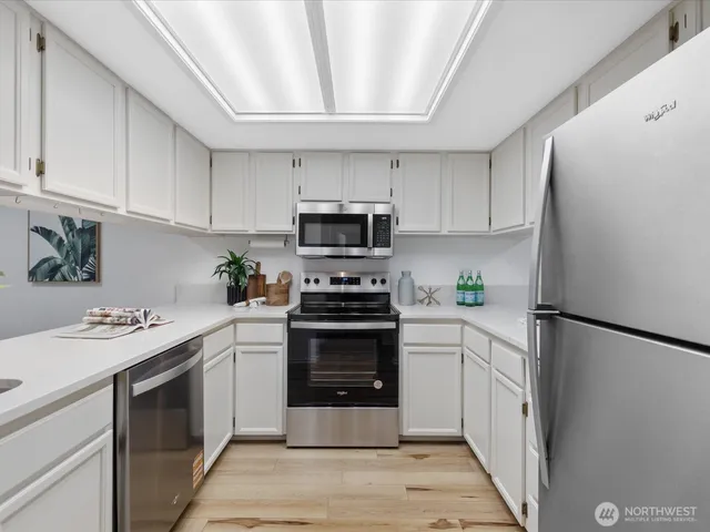 a kitchen with a sink stove and refrigerator