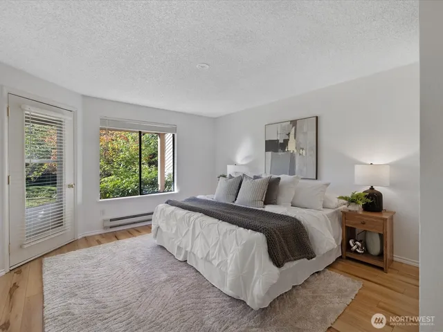 a bed room with a bed and a large window