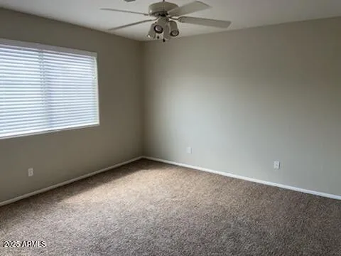 a view of an empty room with a kitchen