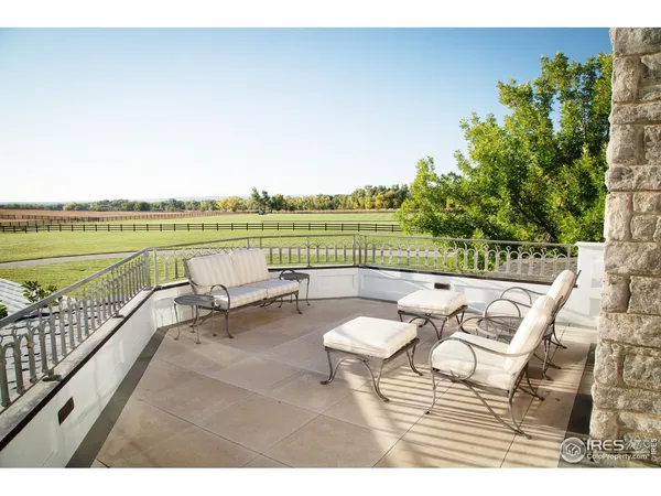 a living room with furniture and a view of kitchen
