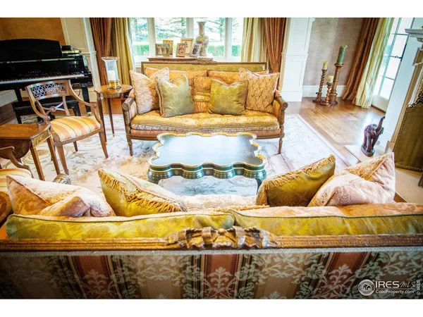 a living room with stainless steel appliances kitchen island granite countertop furniture and a fireplace