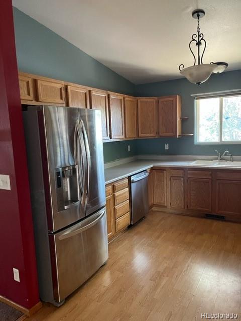 7854 3rd Street Wellington, CO 80549 - Photo 4 of 7 a kitchen with stainless steel appliances granite countertop a refrigerator a sink a stove a washer dryer and a refrigerator