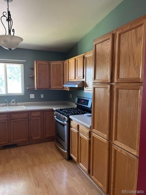 7854 3rd Street Wellington, CO 80549 - Photo 5 of 7 a kitchen with granite countertop stainless steel appliances a refrigerator cabinets and a sink