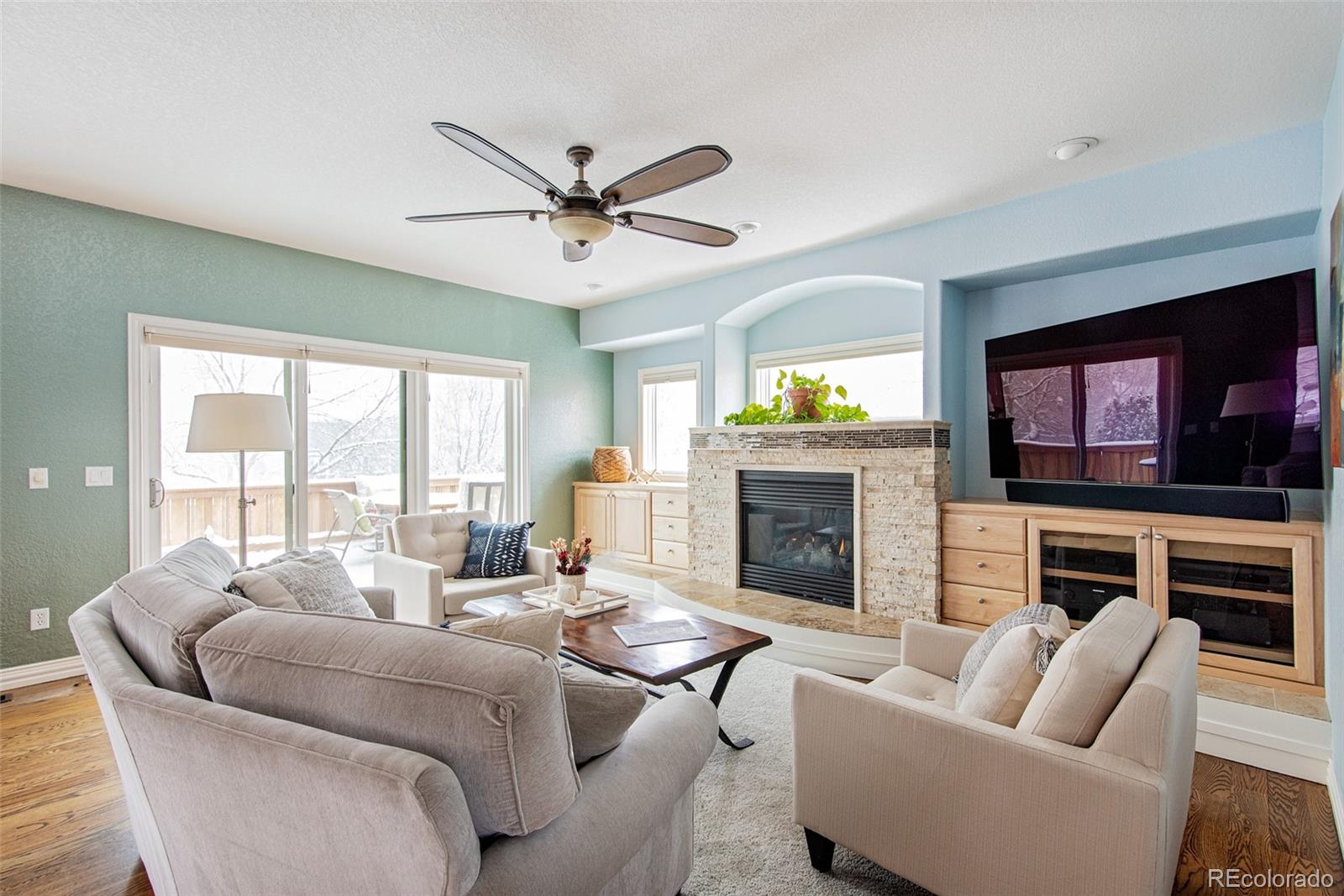 535 Sawtooth Point Lafayette, CO 80026 - Photo 11 of 40 a living room with furniture a fireplace a flat screen tv and a large window