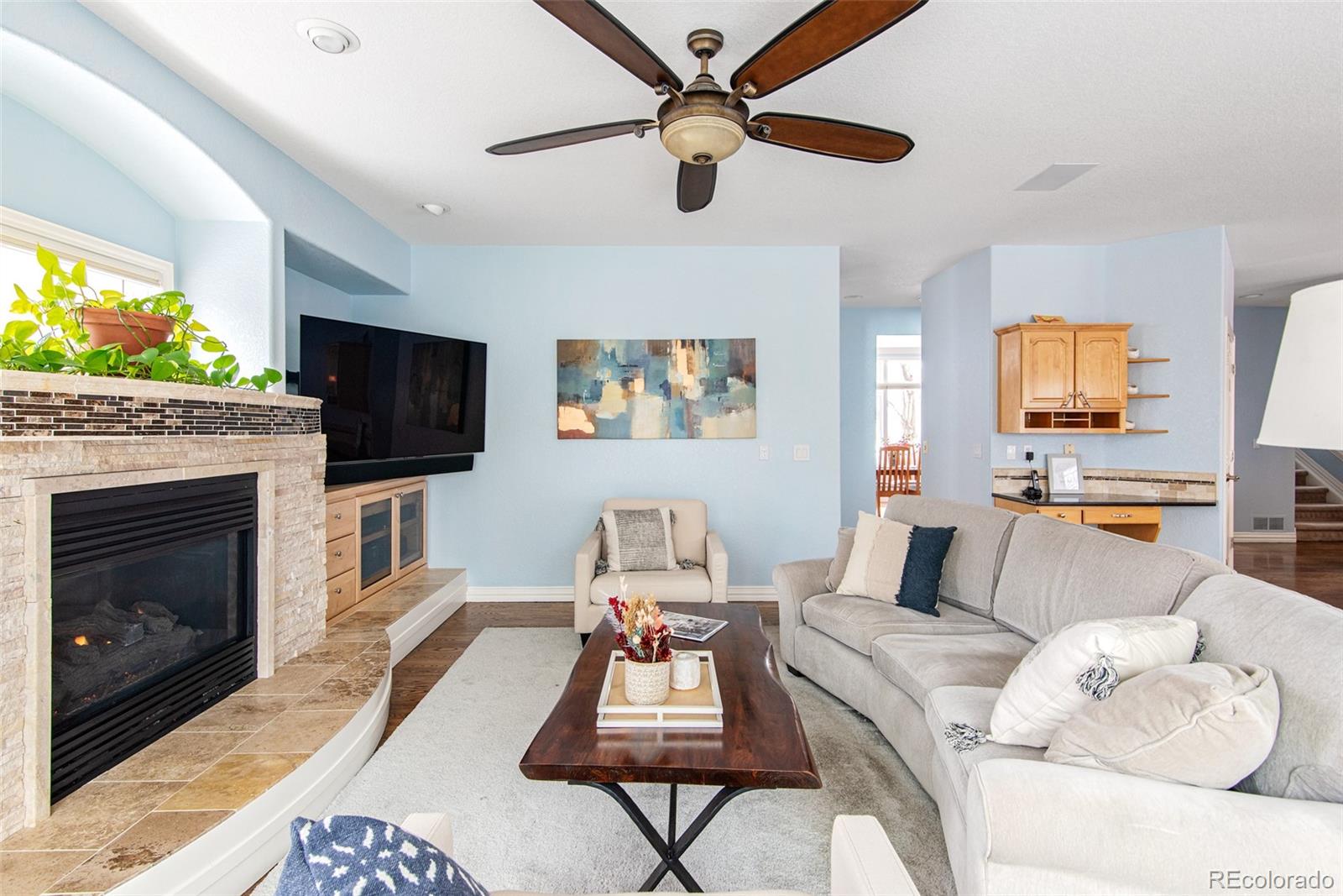 535 Sawtooth Point Lafayette, CO 80026 - Photo 13 of 40 a living room with furniture a flat screen tv and a fireplace