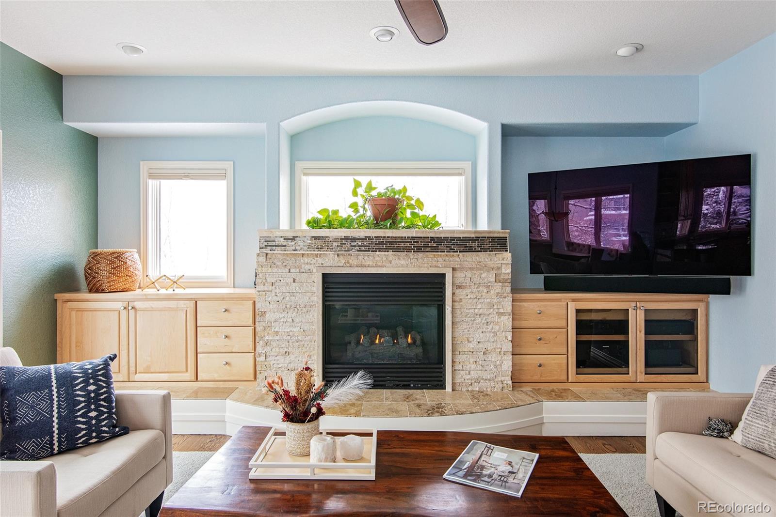 535 Sawtooth Point Lafayette, CO 80026 - Photo 14 of 40 a living room with furniture a flat screen tv and a fireplace