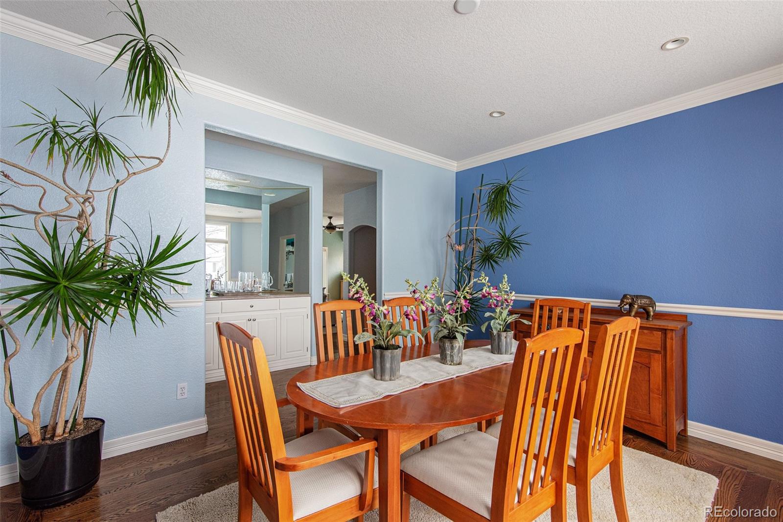 535 Sawtooth Point Lafayette, CO 80026 - Photo 16 of 40 a view of a dining room with furniture and a potted plant
