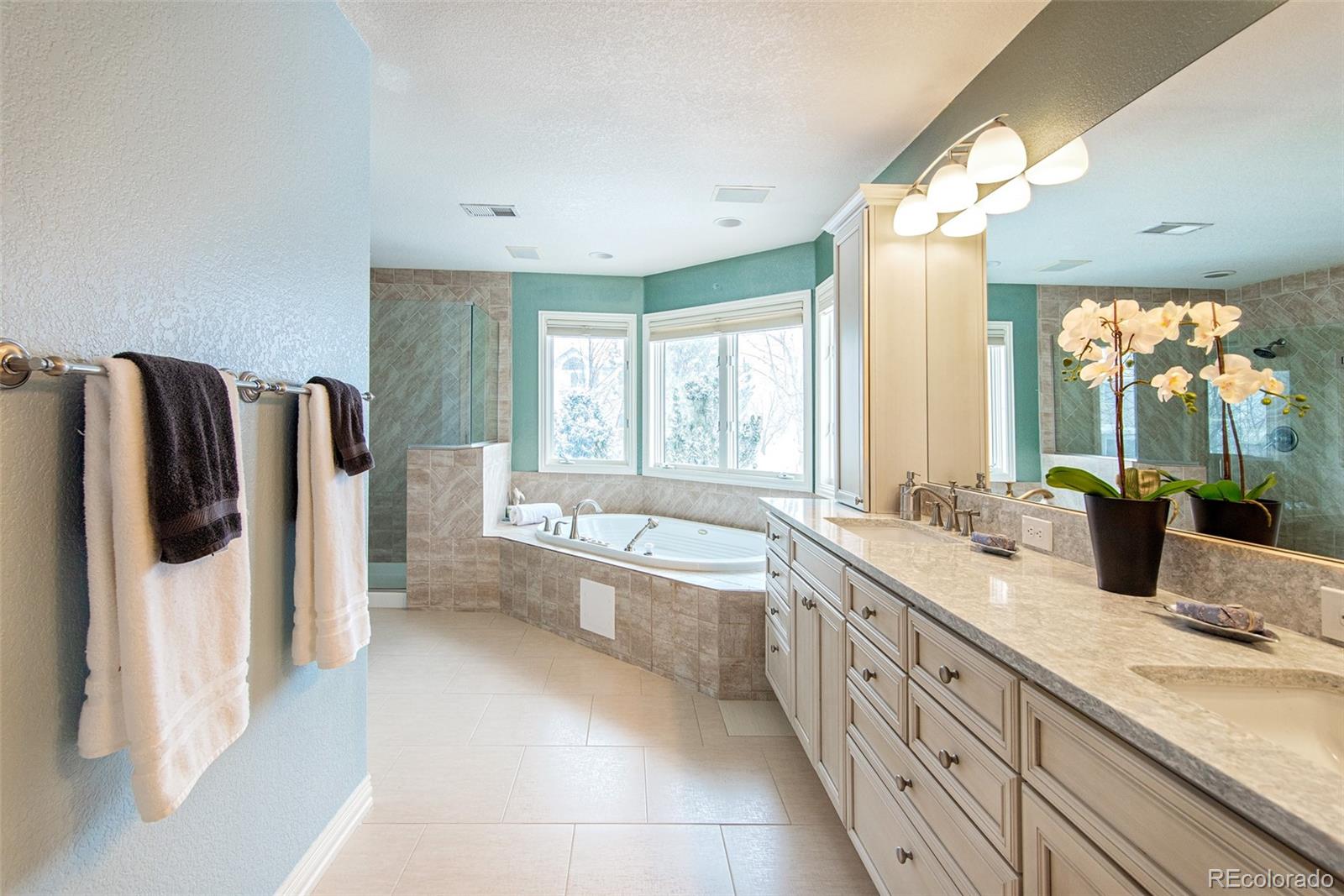 535 Sawtooth Point Lafayette, CO 80026 - Photo 21 of 40 a spacious bathroom with a granite countertop tub sink and mirror