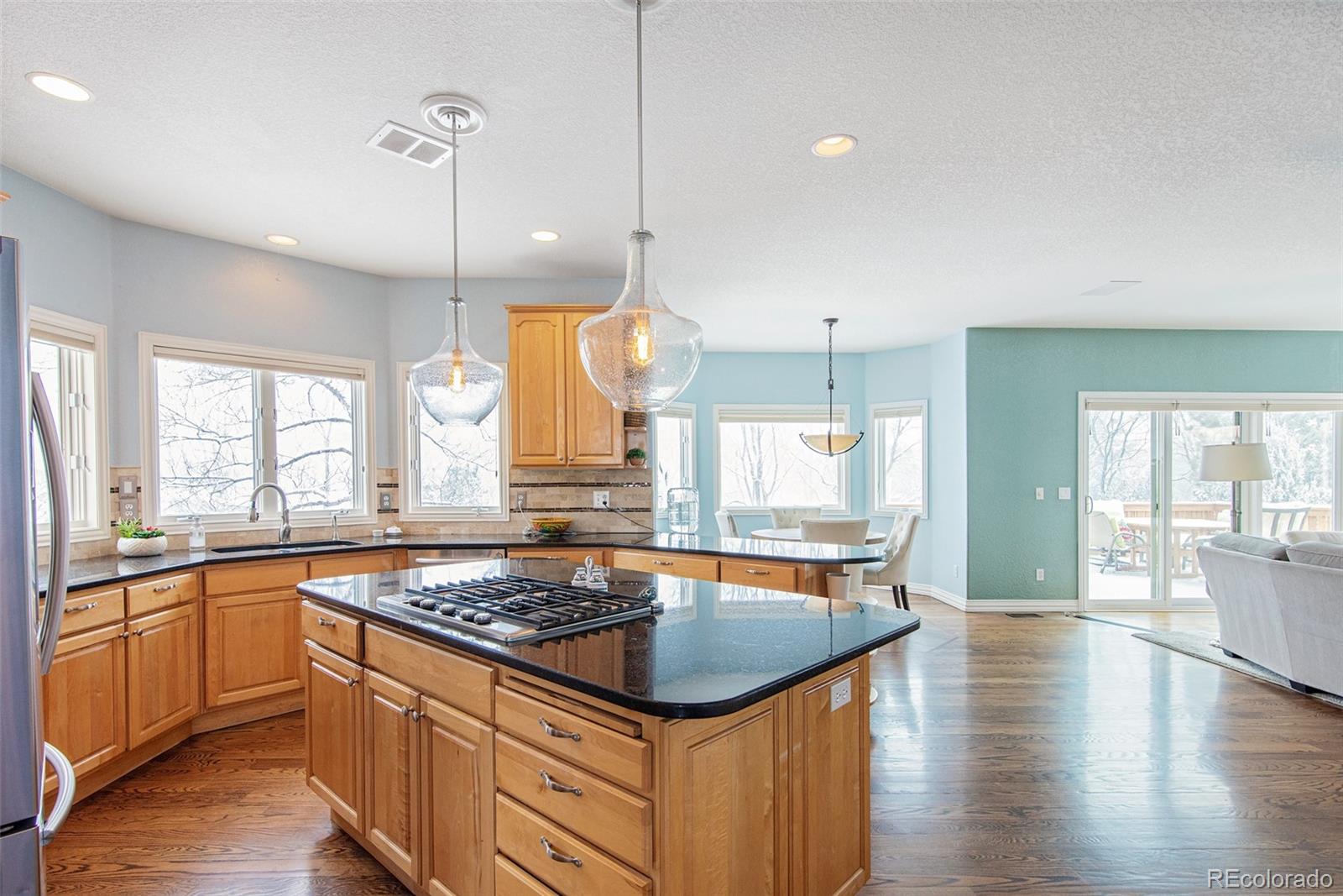 535 Sawtooth Point Lafayette, CO 80026 - Photo 5 of 40 a kitchen with stainless steel appliances granite countertop a sink a stove and a wooden floor
