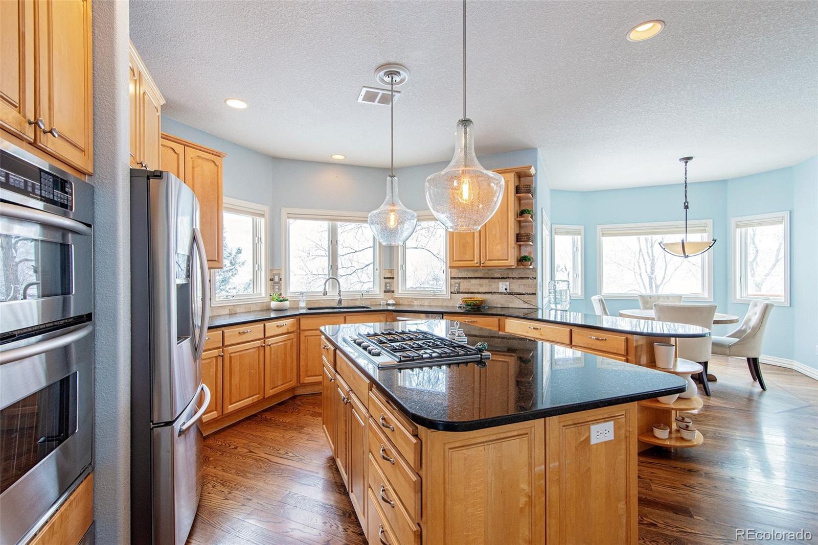 535 Sawtooth Point Lafayette, CO 80026 - Photo 6 of 40 a kitchen with stainless steel appliances granite countertop a sink a stove and a refrigerator